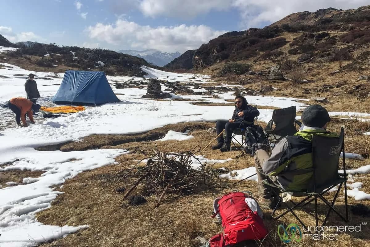 Trekking camp pitched on a snowy ridge along the Druk Path with the Himalaya behind