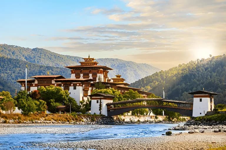 Evening sun on the white walls of Punakha Dzong above the blue Mo Chhu river