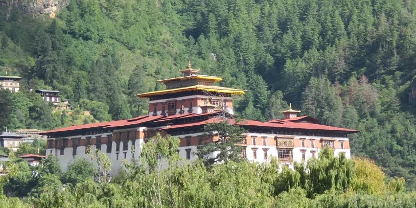 Rinpung Dzong rising above the Paro Chhu on a clear valley morning