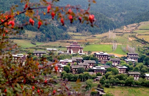 Jambay Lhakhang with its three white towers and golden roofs in the Bumthang valley
