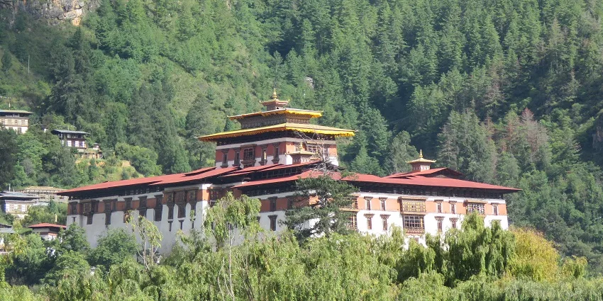 Rinpung Dzong rising above the Paro Chhu on a clear valley morning